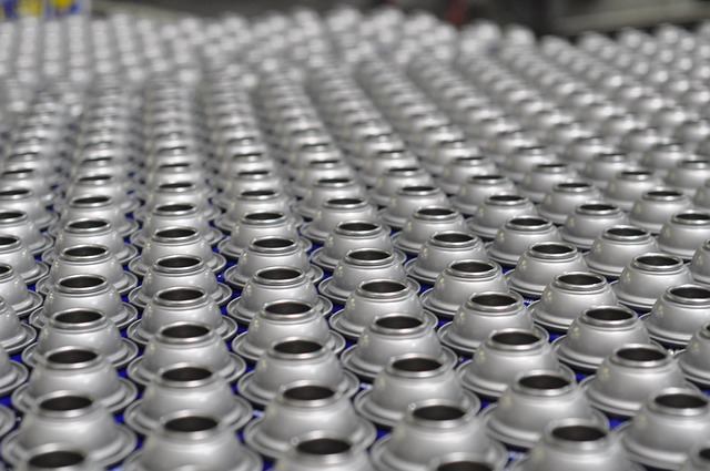 Rows of aluminum cans on a packaging production line at a Cambridge food processing plant