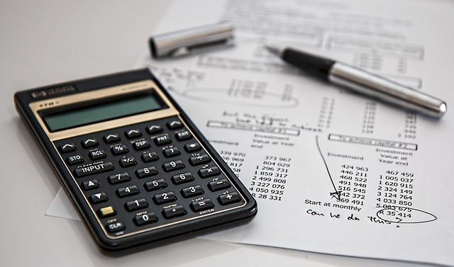 Calculator, pen, and financial paperwork on an insurance broker's desk in Oakville
