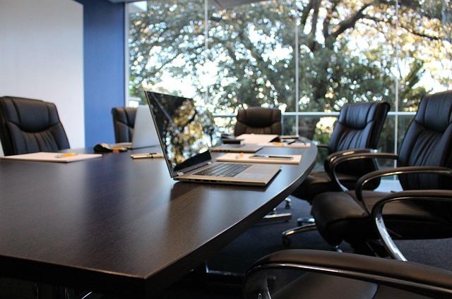 Empty modern boardroom with leather chairs and a laptop at a Markham law firm
