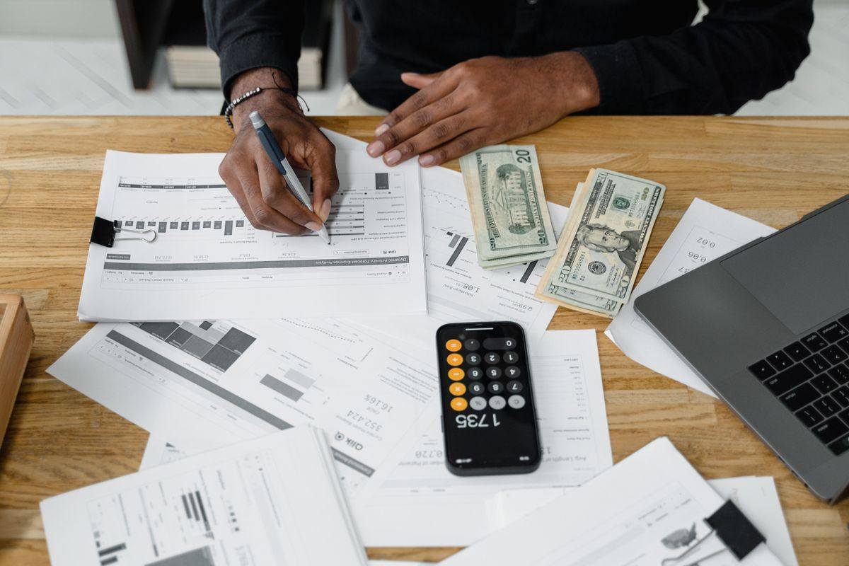 Accountant reviewing financial reports and calculations at a desk