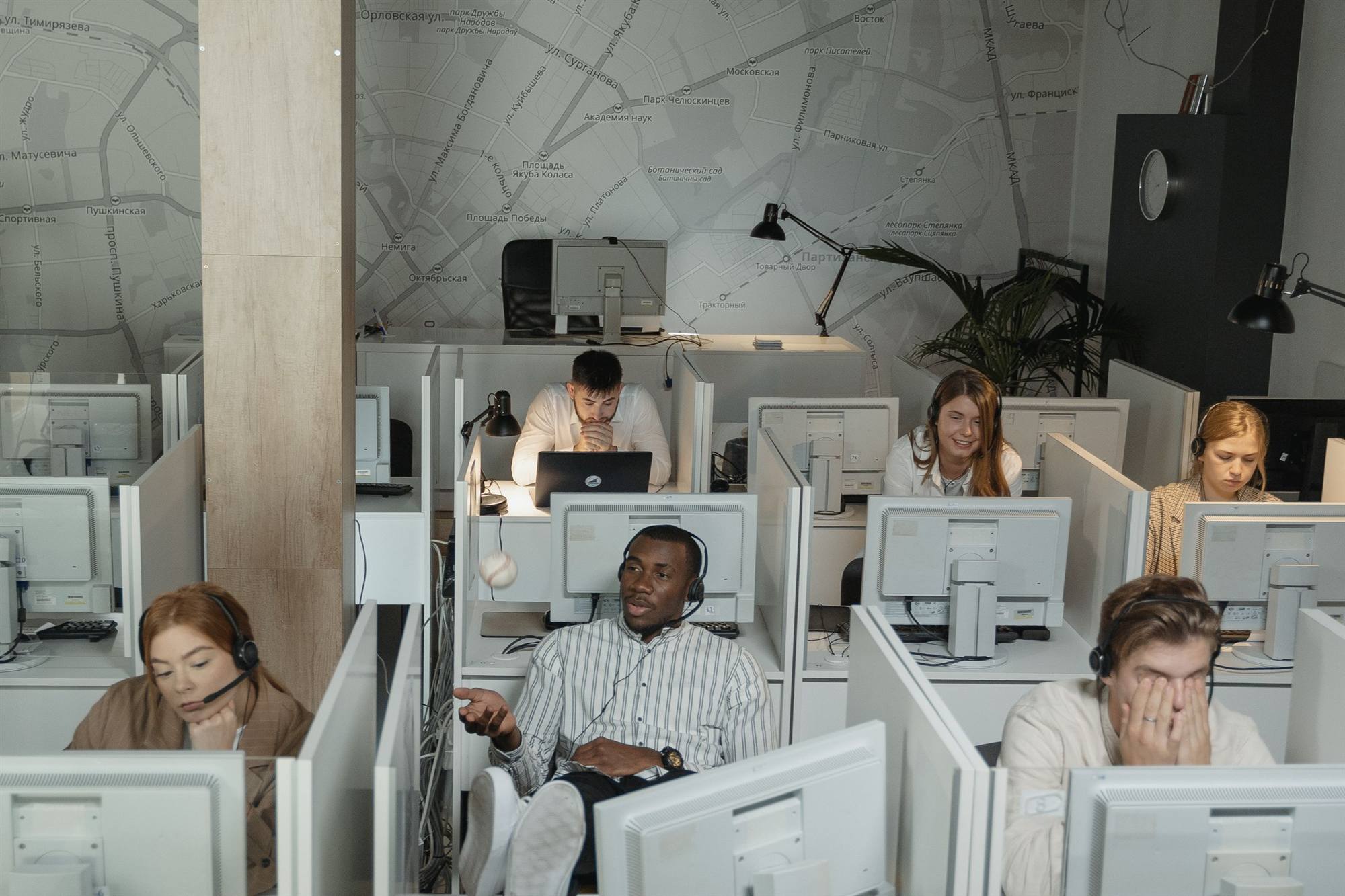 Helpdesk support team working across multiple workstations in an office