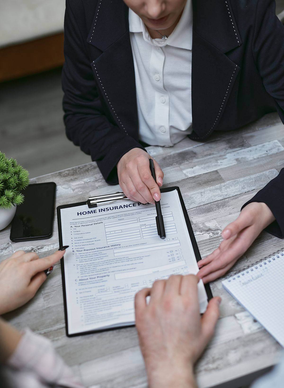 Insurance broker reviewing a home insurance policy on a clipboard, managed IT support for insurance brokers in Markham