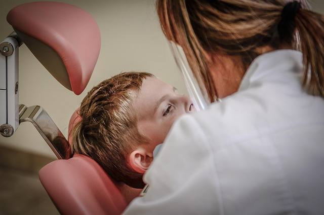 Dentist examining a young patient, PHIPA-compliant IT support for dental practices in Richmond Hill