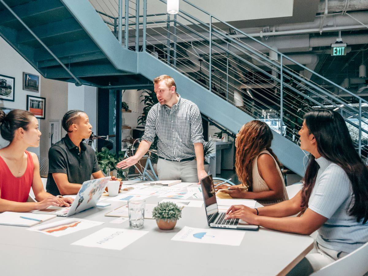 Non-profit team reviewing compliance analysis documents in an open-plan Toronto office, managed IT support for non-profits