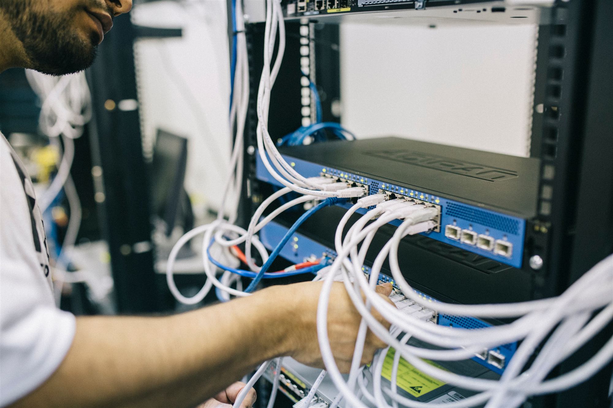 IT technician configuring network server rack cabling for a managed IT client in the Greater Toronto Area