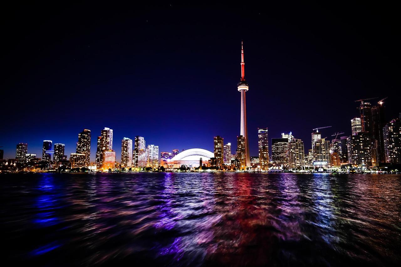 Toronto waterfront skyline at night with the CN Tower and Rogers Centre