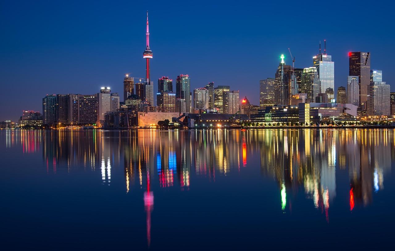 Toronto skyline at dusk with the CN Tower and waterfront reflections