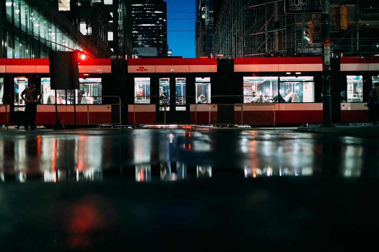 TTC streetcar at night on a rain-slicked downtown Toronto street